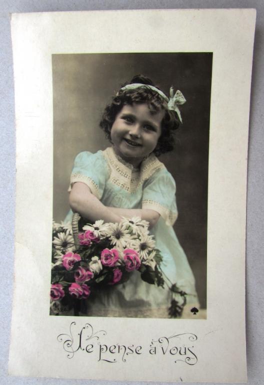 Девочка в голубом платье с бантом и корзиной цветов