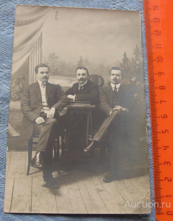 Фотография.Трое мужчин сидят у стола. До 1917 г.