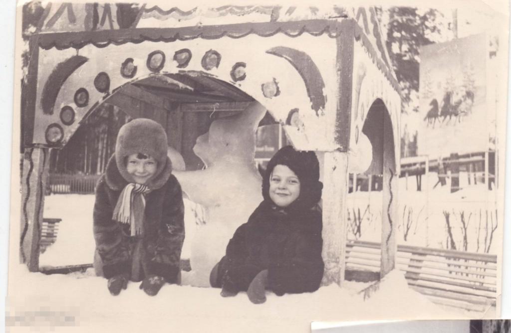 Двое маленьких детей зимой в детском городке. 1960-е гг.